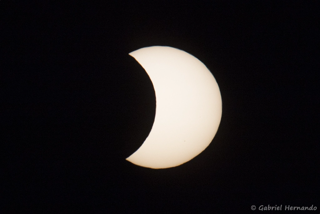20h44, le croissant solaire se teinte de couleurs chaudes, à mesure que l'astre descend vers l'horizon